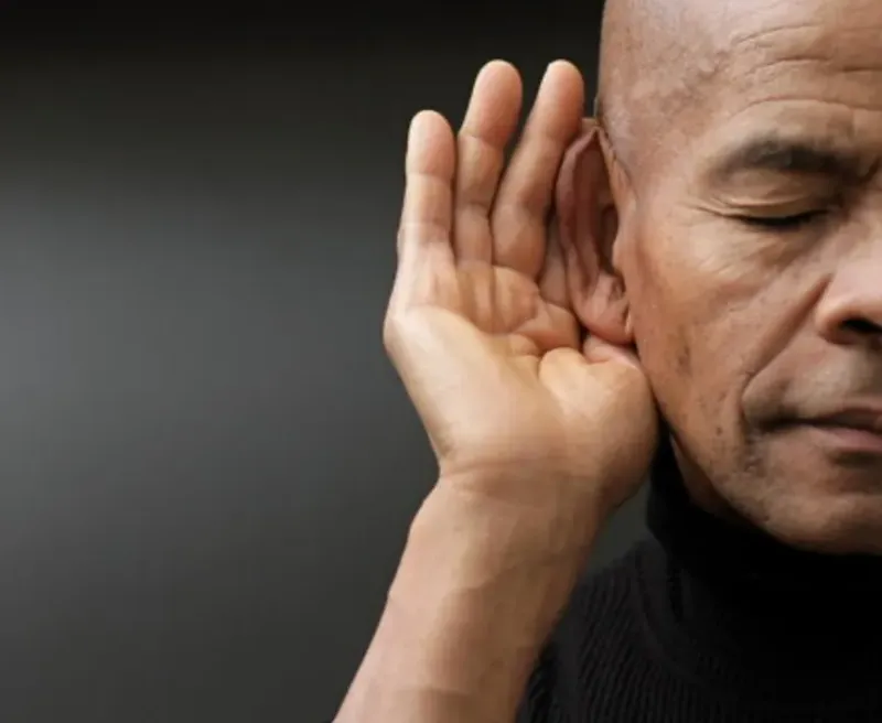 Man cupping his hand behind his ear